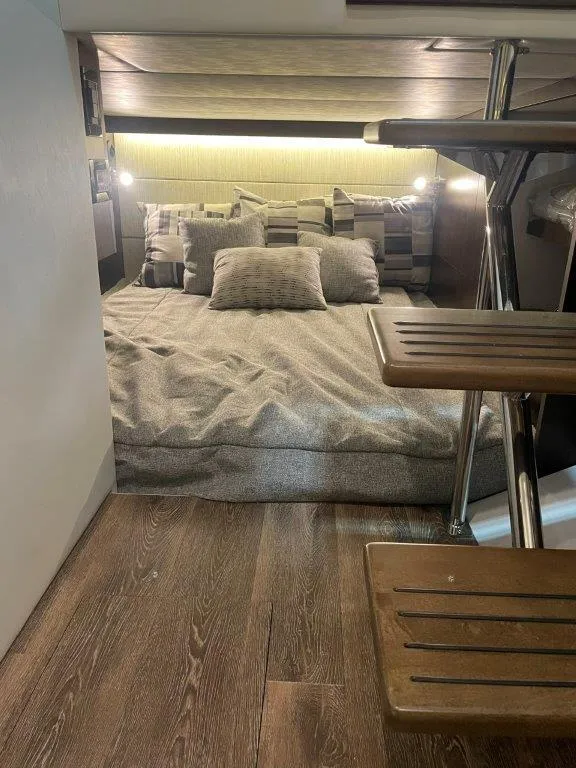 Slide: The Image of 2023 Cruisers Yachts 38 GLS OB cabin interior with bed and wooden flooring. - 22