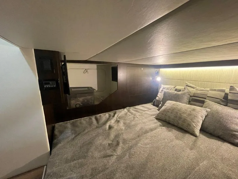 Slide: The Image of 2023 Cruisers Yachts 38 GLS OB cabin interior with cozy bed and modern lighting. - 24