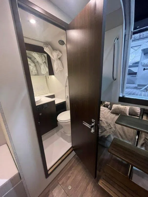 Slide: The Image of 2023 Cruisers Yachts 38 GLS OB bathroom interior with wooden door and modern fixtures. - 25