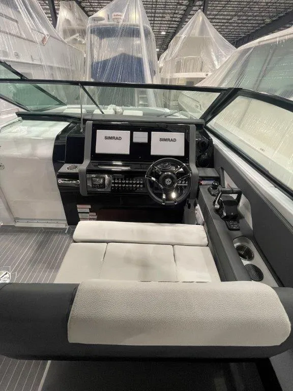 Slide: The Image of 2023 Cruisers Yachts 38 GLS OB helm with dual Simrad displays and modern controls. - 29