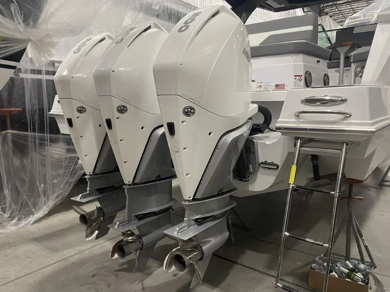 Slide: The Image of 2023 Cruisers Yachts 38 GLS OB with triple outboard engines in a showroom. - 30