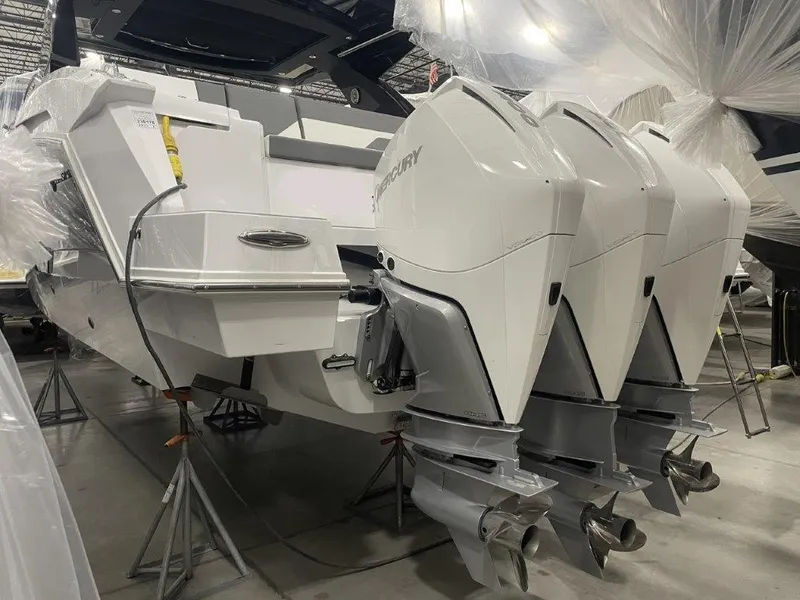 Slide: The Image of 2023 Cruisers Yachts 38 GLS OB with triple Mercury outboard engines in a showroom. - 31