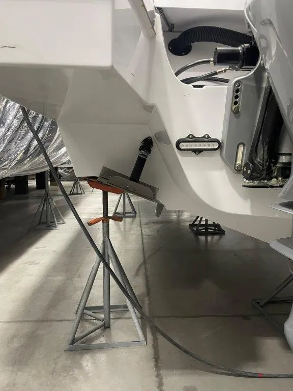 Slide: The Image of 2023 Cruisers Yachts 38 GLS OB in dry dock, showing the stern and support stands. - 32