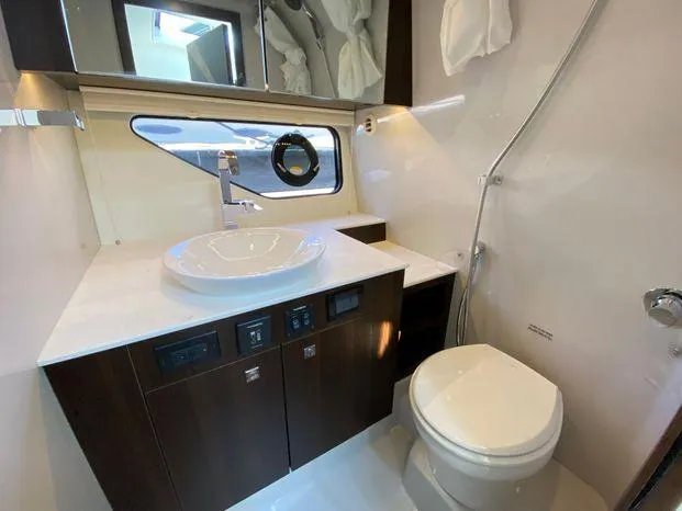Slide: The Image of Modern bathroom in 2023 Cruisers Yachts 38 GLS OB, featuring a sleek sink and toilet. - 5