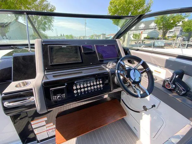 Slide: The Image of 2023 Cruisers Yachts 38 GLS OB helm station with modern controls and navigation screens. - 7