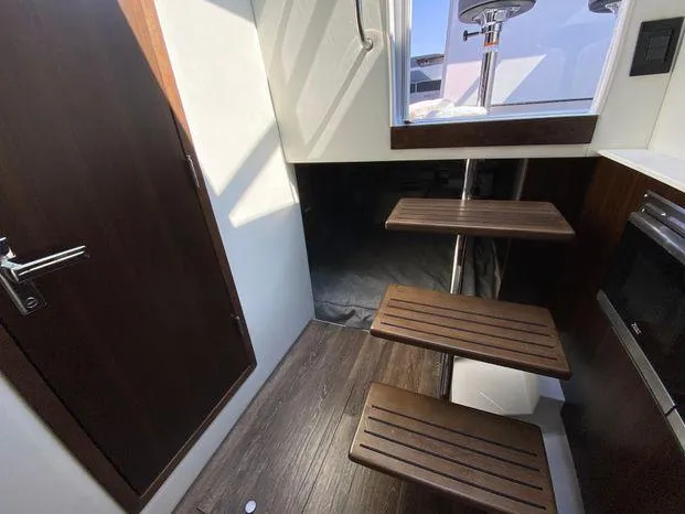 Slide: The Image of 2023 Cruisers Yachts 38 GLS OB interior with wooden steps and modern design. - 9