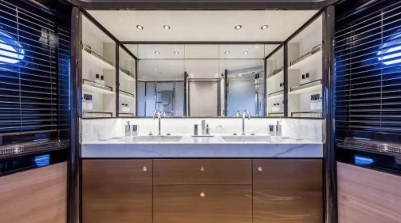 Slide: The Image of Luxurious bathroom interior of Absolute NAVETTA 75 yacht, featuring dual sinks and elegant wood cabinetry. - 12