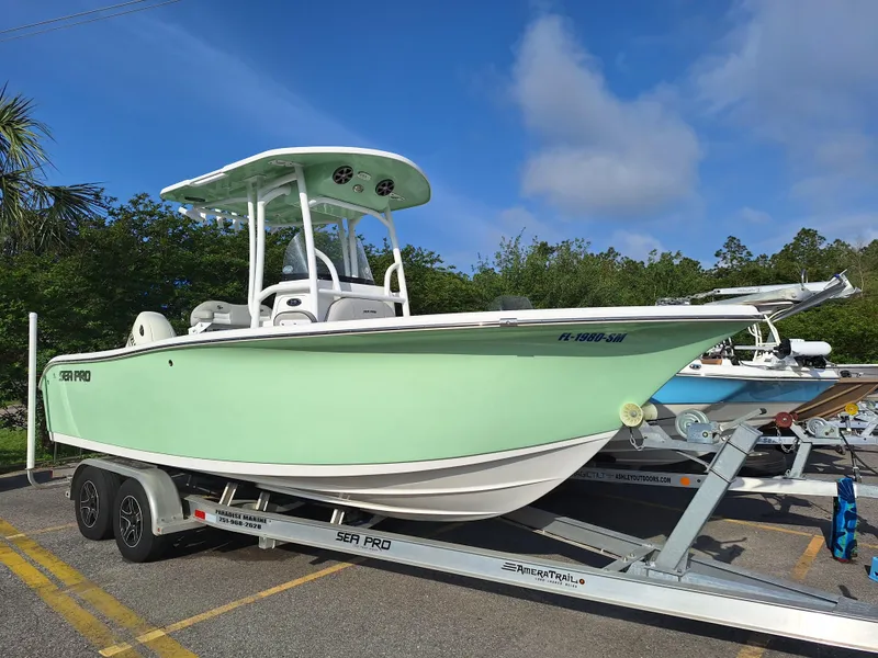 The Image of 2020 Sea Pro 219 Center Console boat on trailer in parking lot. - 1