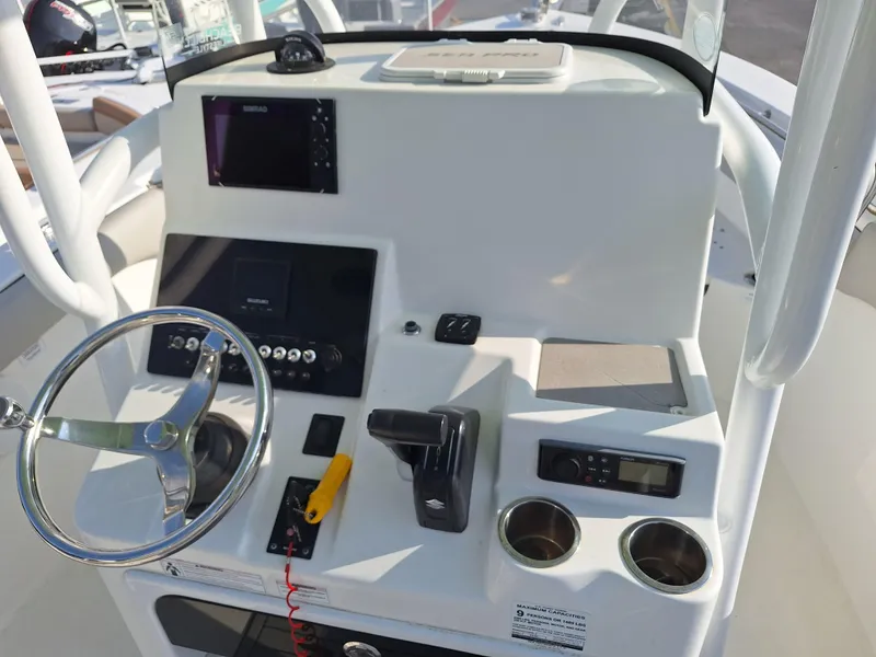 Slide: The Image of 2020 Sea Pro 219 Center Console boat dashboard with steering wheel and electronic controls. - 5