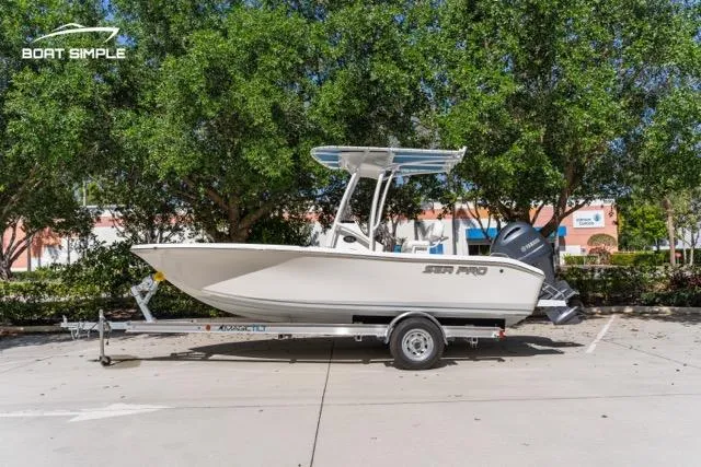 Slide: The Image of 2023 Sea Pro 199 Deep V Center Console boat on trailer, parked outdoors. - 1