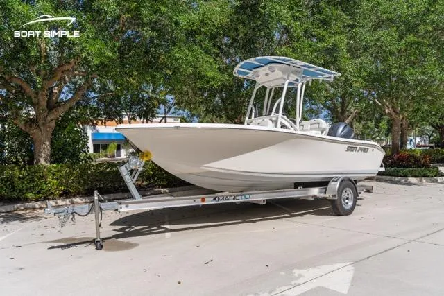 Slide: The Image of 2023 Sea Pro 199 Deep V Center Console boat on trailer, parked outdoors. - 2