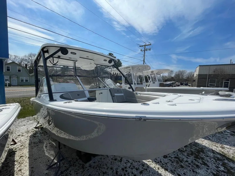 Slide: The Image of 2024 Sea Pro 240 Dual Console boat on display under a clear blue sky. - 2