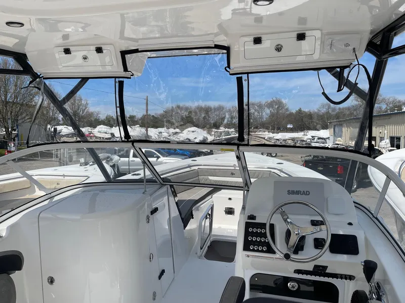 Slide: The Image of 2024 Sea Pro 240 Dual Console boat interior with steering wheel and dashboard. - 8