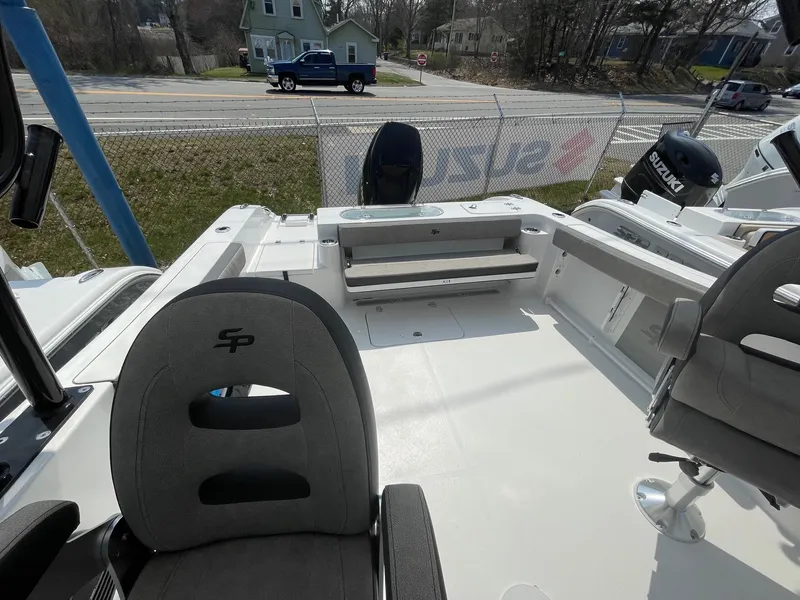 Slide: The Image of 2024 Sea Pro 240 Dual Console boat interior with seating and helm chairs. - 9