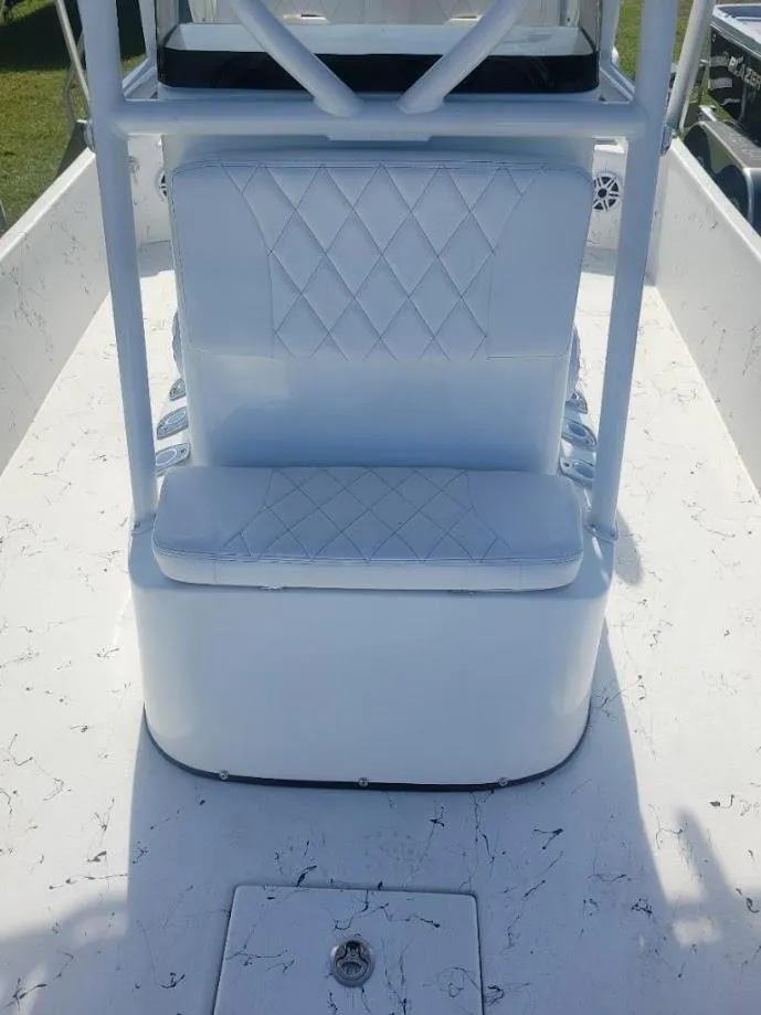 Slide: The Image of 2024 Blazer Bay 2400 boat with rod holders and storage compartment. - 10