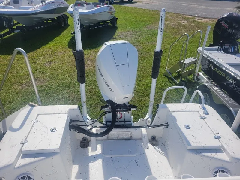 Slide: The Image of 2024 Blazer Bay 2400 boat interior with white cushioned seating. - 12