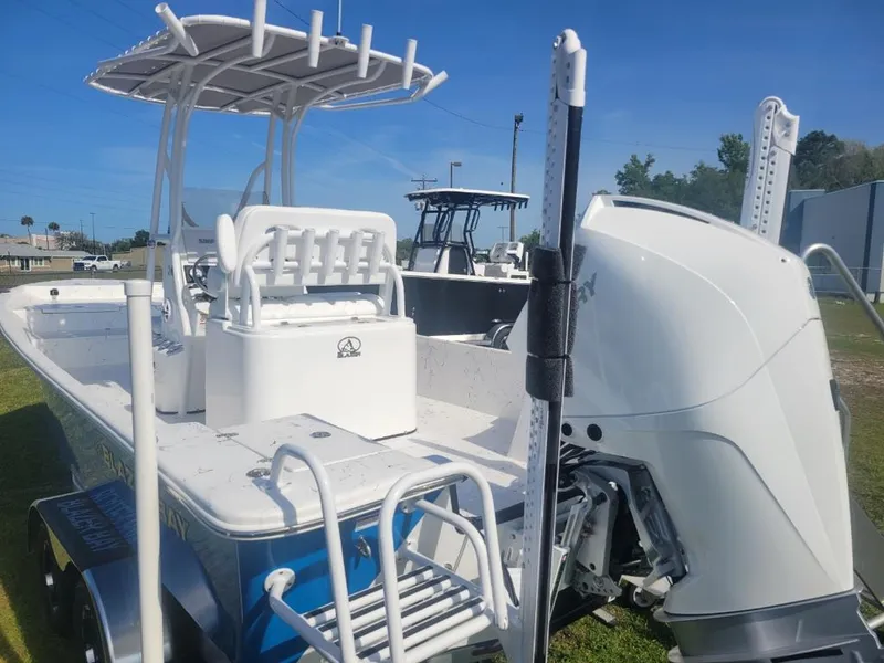 Slide: The Image of 2024 Blazer Bay 2400 boat console with steering wheel and Simrad electronics. - 13