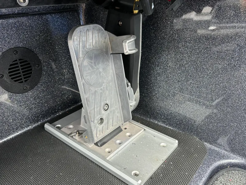 Slide: The Image of 2024 Triton 19 TrX boat foot pedal and control mechanism. - 10