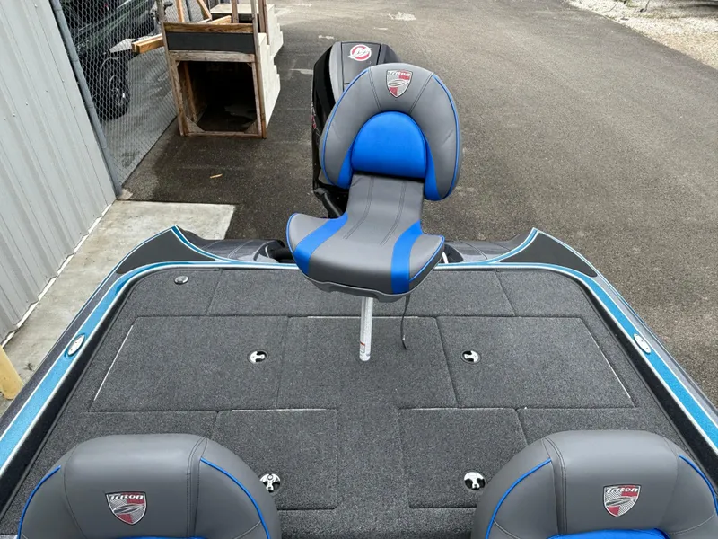 Slide: The Image of 2024 Triton 19 TrX bass boat with blue and gray seating. - 12
