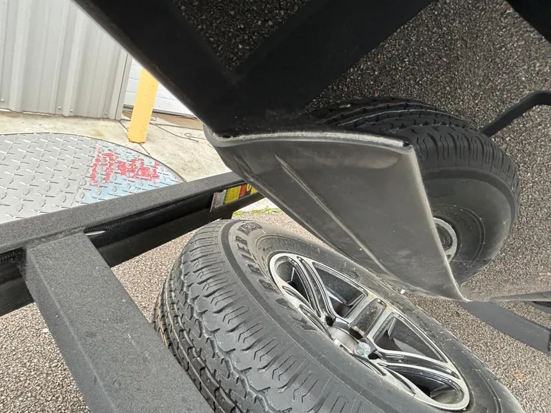Slide: The Image of Close-up of 2024 Triton 19 TrX trailer tire and boat hull. - 2
