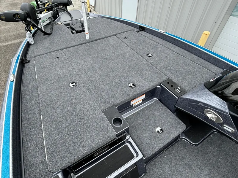 Slide: The Image of 2024 Triton 19 TrX boat deck with storage compartments and fishing equipment. - 5