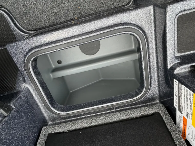 Slide: The Image of 2024 Triton 19 TrX storage compartment interior. - 7