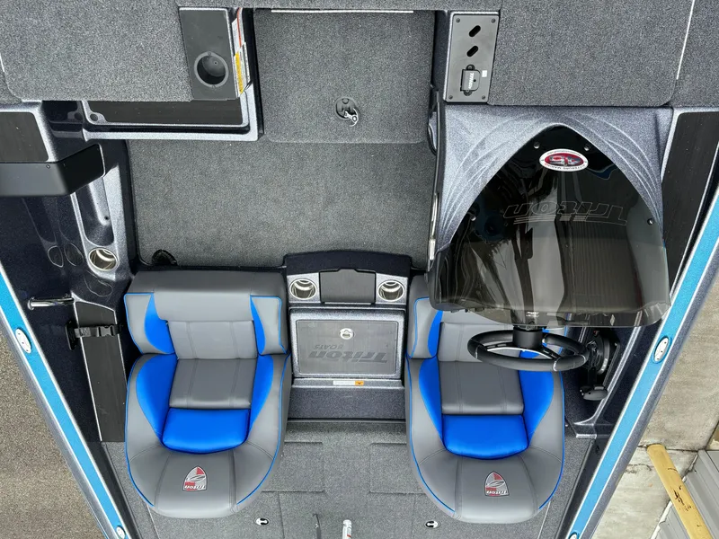 Slide: The Image of 2024 Triton 19 TrX boat interior with dual seats and steering console. - 8