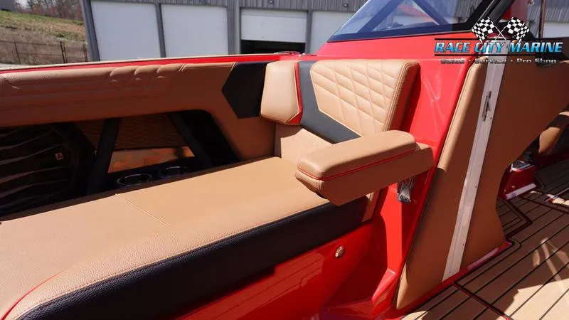 Slide: The Image of 2024 Nautique Super Air Nautique G23 interior with tan and red upholstery. - 14