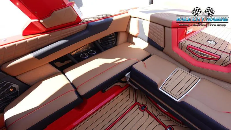 Slide: The Image of 2024 Nautique Super Air Nautique G23 interior with tan and red upholstery. - 17