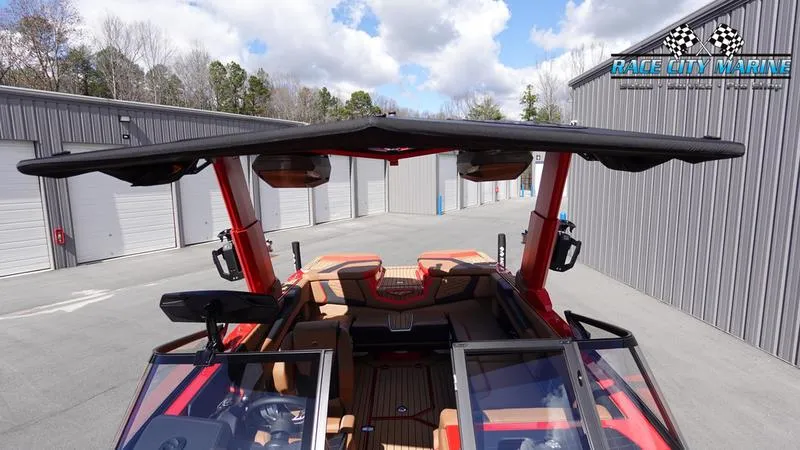 Slide: The Image of 2024 Nautique Super Air Nautique G23 boat with open canopy and modern interior. - 19