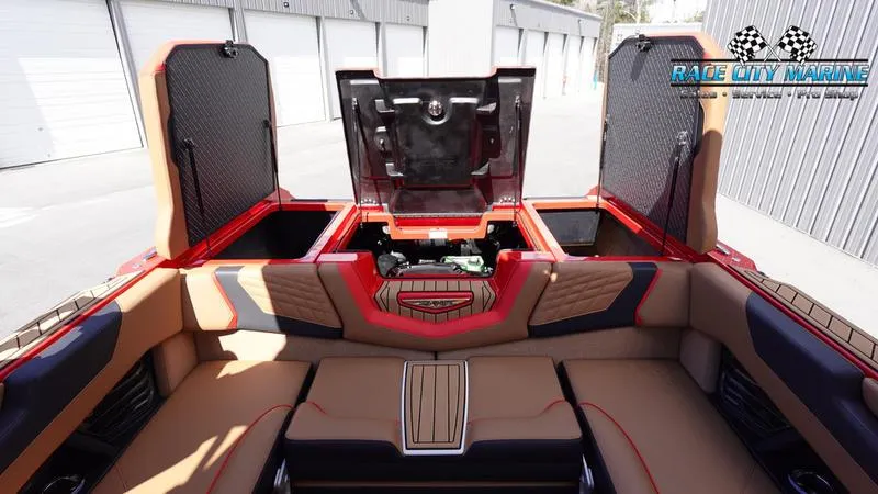 Slide: The Image of 2024 Nautique Super Air Nautique G23 interior with open storage compartments. - 21