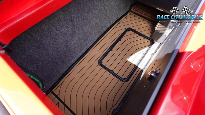 Slide: The Image of 2024 Nautique Super Air Nautique G23 storage compartment with teak flooring. - 25