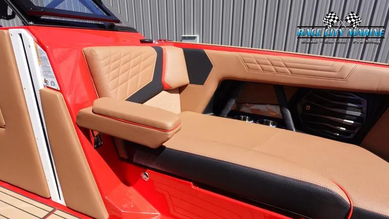 Slide: The Image of 2024 Nautique Super Air Nautique G23 interior with tan and black upholstery. - 27