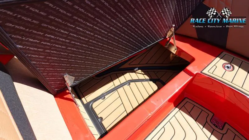 Slide: The Image of 2024 Nautique Super Air Nautique G23 storage compartment with teak flooring. - 29