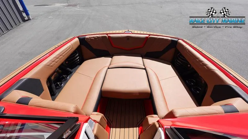 Slide: The Image of 2024 Nautique Super Air Nautique G23 boat interior with tan seating and red accents. - 35