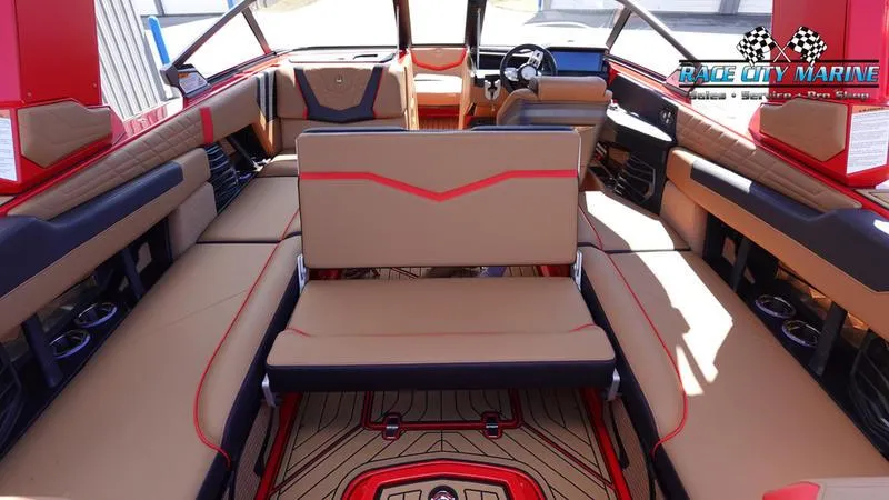 Slide: The Image of 2024 Nautique Super Air Nautique G23 interior with tan and red upholstery, spacious seating, and modern design. - 36