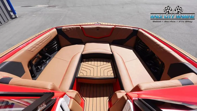 Slide: The Image of 2024 Nautique Super Air Nautique G23 boat interior with tan and black seating. - 37