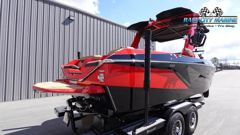 Slide: The Image of 2024 Nautique Super Air Nautique G23 boat in red and black on a trailer. - 39