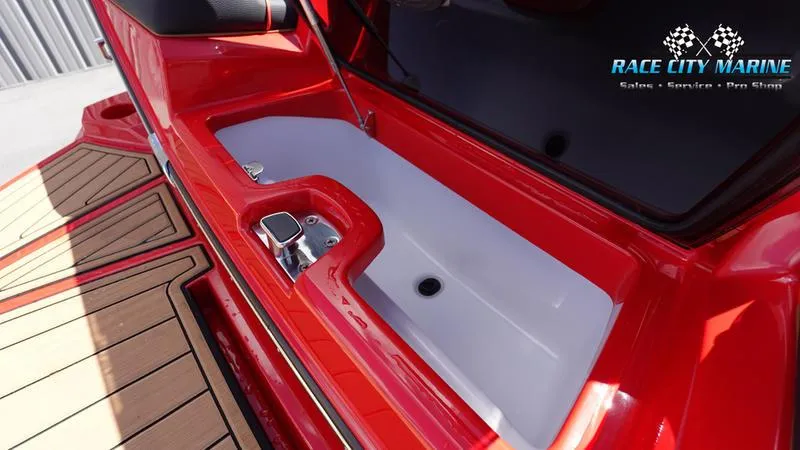 Slide: The Image of 2024 Nautique Super Air Nautique G23 boat interior storage compartment, red and white design. - 4