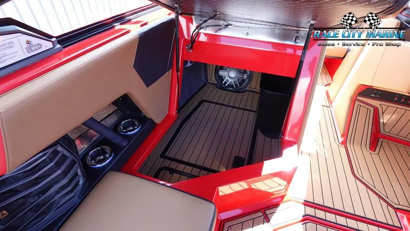 Slide: The Image of 2024 Nautique Super Air Nautique G23 interior with red accents and premium seating. - 46