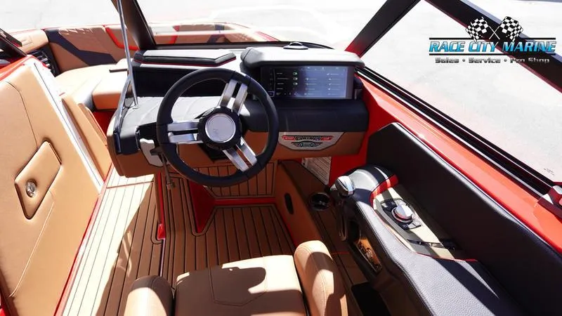 Slide: The Image of 2024 Nautique Super Air Nautique G23 boat interior with steering wheel and dashboard. - 48