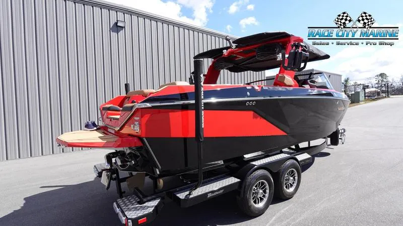 Slide: The Image of 2024 Nautique Super Air Nautique G23 boat in red and black on a trailer. - 5