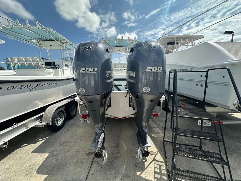 Slide: The Image of Ocean Master 27 boat with twin Yamaha 200 engines, 2023 model, docked at marina. - 3