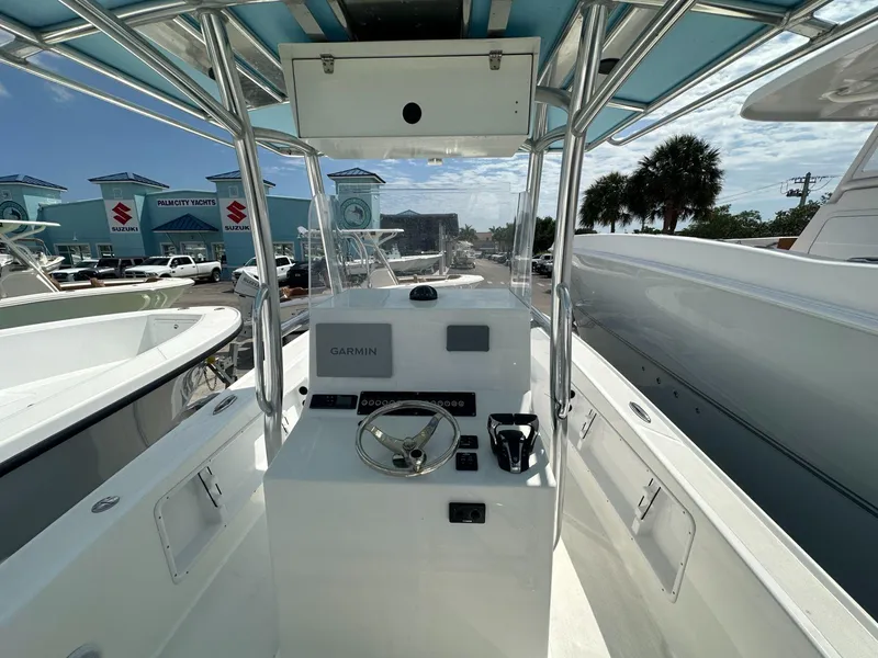 Slide: The Image of Ocean Master 27 boat console with Garmin navigation, Palm City Yachts dealership in background. - 4