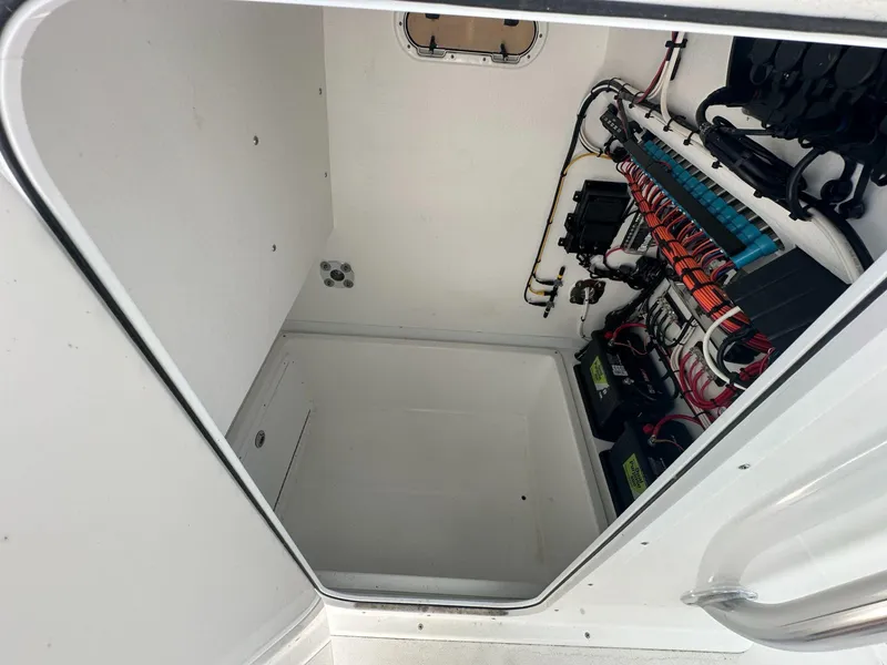 Slide: The Image of Electrical compartment of 2023 Ocean Master 27 boat with wiring and batteries. - 7