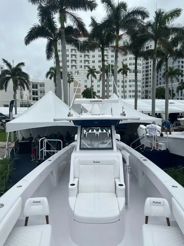 Slide: The Image of 2024 Bahama 41' Open Fisherman GT boat on display at a marina event. - 12