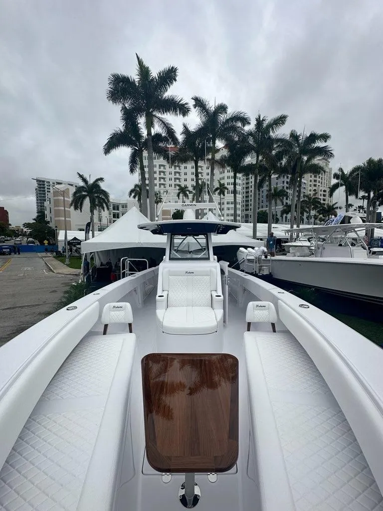 Slide: The Image of 2024 Bahama 41' Open Fisherman GT boat with luxurious seating and palm trees in the background. - 13