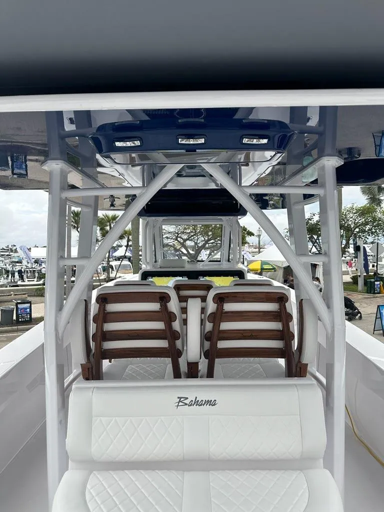 Slide: The Image of 2024 Bahama 41' Open Fisherman GT interior with white seating and wooden accents. - 9