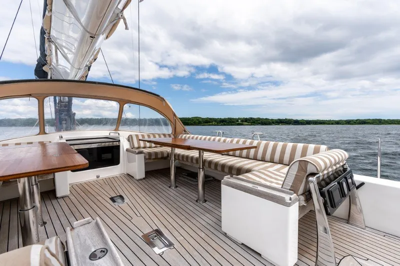 Slide: The Image of Spacious deck of 2005 Nautor Swan 82S yacht with striped seating and ocean view. - 10