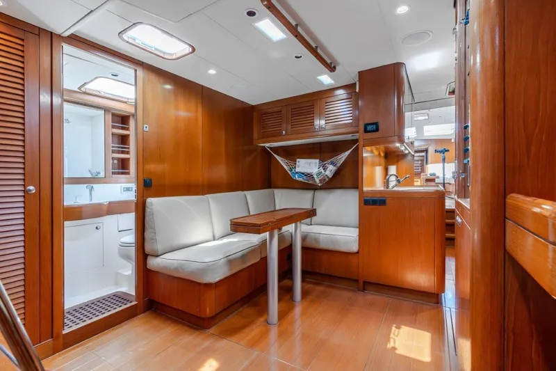 Slide: The Image of Interior of 2005 Nautor Swan 82S yacht with wooden finishes and cozy seating area. - 20